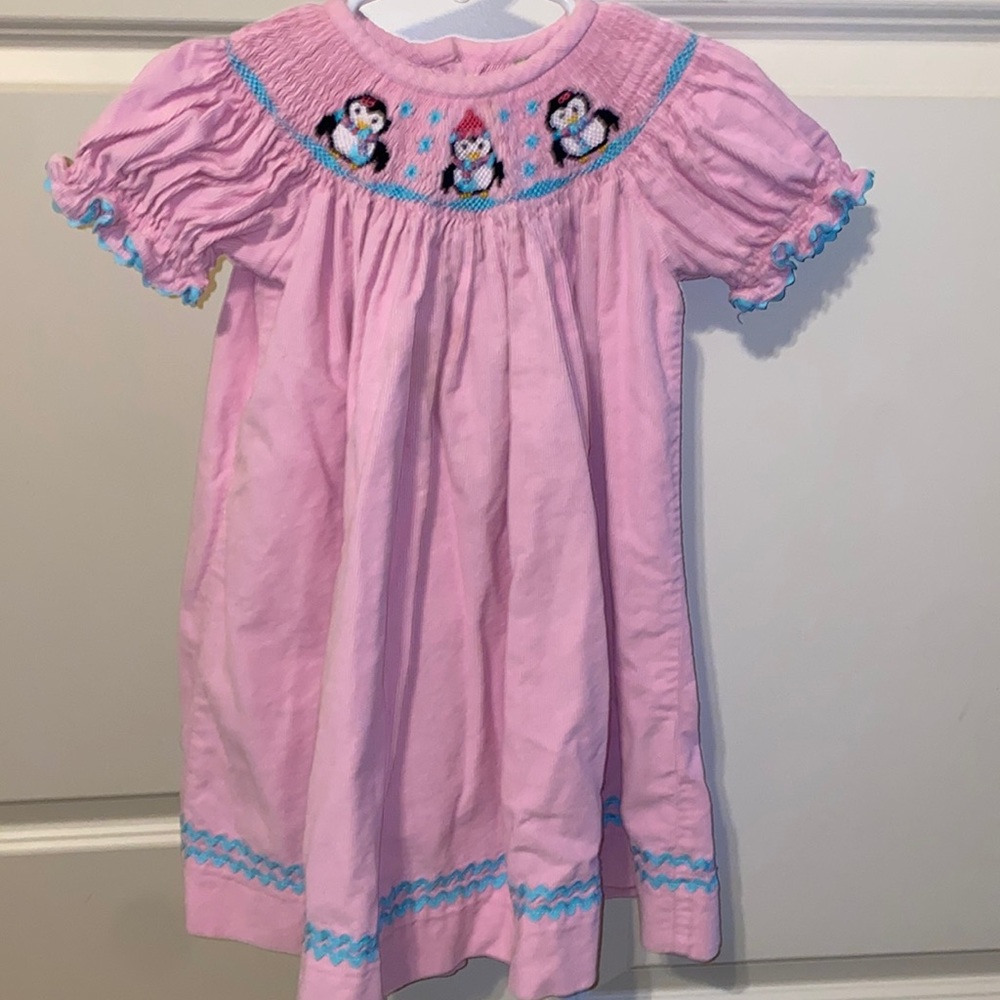 Pink corduroy smocked dress with penguins in snow
